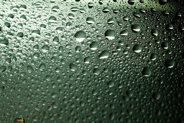 Drops of water on a color background. Selective focus. Gray