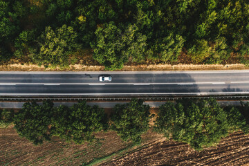 Automobile on highway road, top view aerial shot from drone pov
