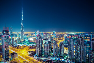 Fantastic nighttime skyline of a big modern city. Rooftop perspective of downtown Dubai, UAE.