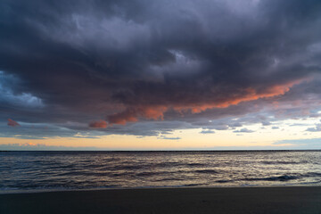 Naklejka na ściany i meble Sunset sky over sea at the beach