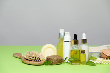 Natural cosmetics for face and body skin care, hair. Plastic-free, eco-friendly packaging. On a green and gray background