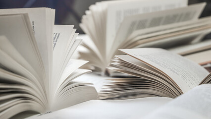 stack of books, close up. Open book on the table in library. Back to school concept. Open book on...