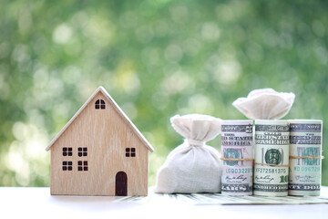 Finance, Model house and money banknote on natural green background, Saving money for new home...