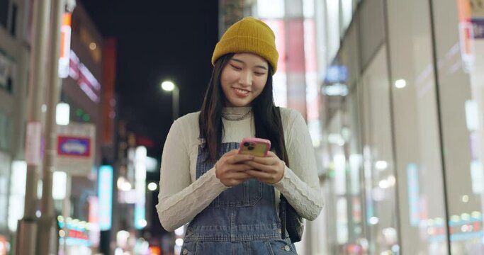 Typing, city and Japanese woman with smartphone, walking and connection with social media, network and post. Digital app, person and girl with a cellphone, internet and smile with break or street