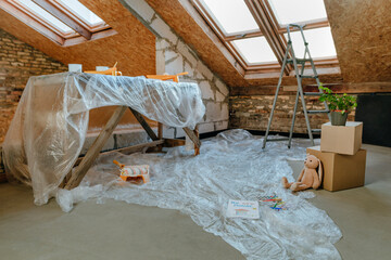 Table and floor covered in plastic at home