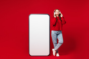 Full body young woman wear sweater white hat casual clothes big huge blank screen area mobile cell...