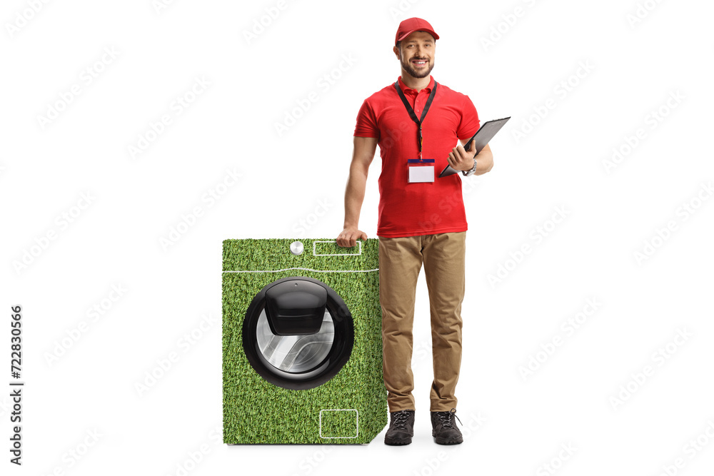 Wall mural Full length portrait of a retail assitant leaning on a green sustainable washing machine