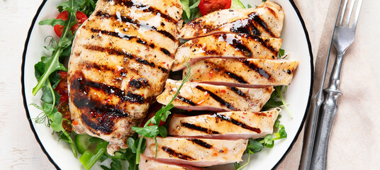 Roasted chicken breast, fillet and fresh vegetable salad.