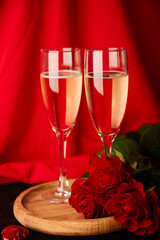 Traditional romantic St Valentines day background with glasses of champagne, red roses.