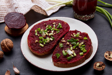 Beetroot spread sandwiches with spring young onion, garlic and walnuts. Natural beetroot juice. Vegan healthy spring food. Top view