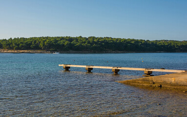 A pier on the coast of Kasteja Forest Park - Park Suma Kasteja - in Medulin, Istria, Croatia....