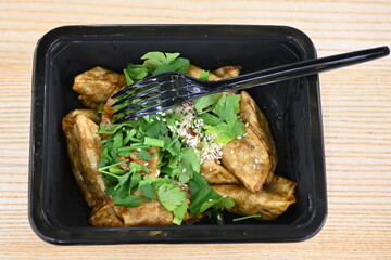 Gyoza Japanese korean dumplings  in disposable black dishes, Chinese dumplings street food