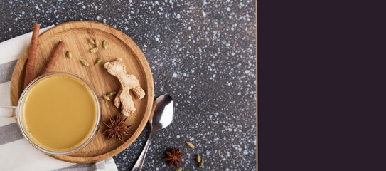 Cup of healthy, traditional masala tea with spices dried ginger, star anise, cinnamon flat lay....