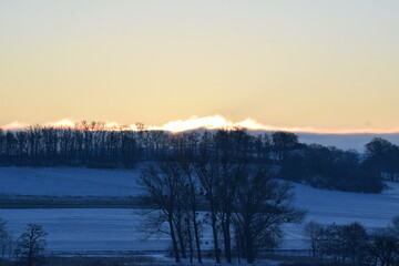 winter sunrise above snow covered land