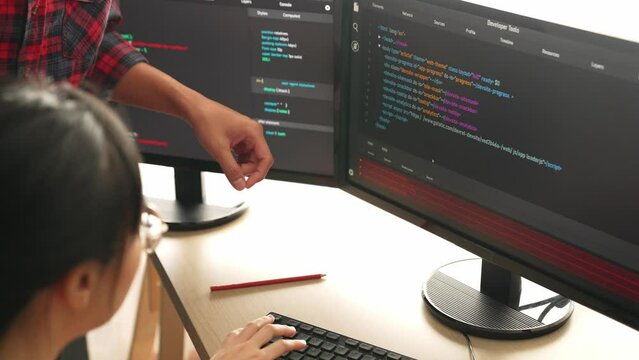 Slow motion back end or software developer manager supervising his team on new application program development on debugging and solving complex code algorithms on monitor. Burgeoning