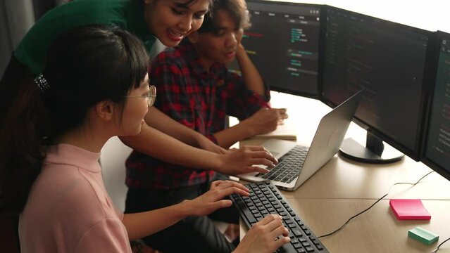Back end software developer engineer for computer programming working together on debugging writing computing code, solving complex algorithms display on monitor in office. Burgeoning