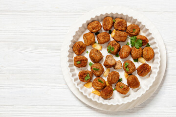 baked meatballs in white baking dish, top view