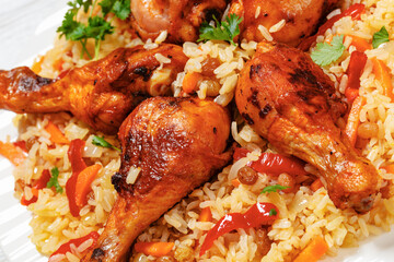 fried chicken drumsticks over rice pilaf, top view