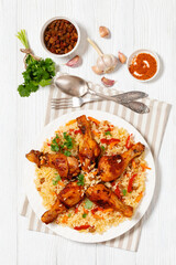 fried chicken drumsticks over rice pilaf, top view