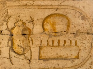 ancient egyptian wall with hieroglyphs and scarab 
