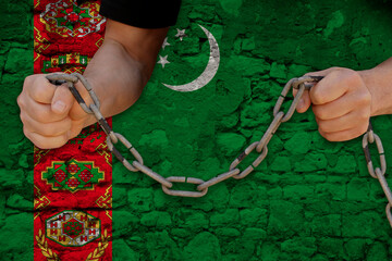 male dark hands tearing iron chains, national flag state Turkmenistan, concept of war, revolution,...