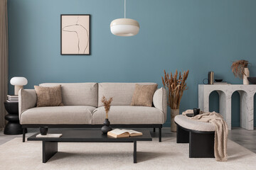 Creative composition of living room interior with mock up poster frame, grey sofa, black coffee table, blue wall, stylish furnitures, decorations and personal accessories. Template. Home decor. 