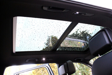 Panoramic sunroof in a car. Panoramic double sunroof with wind deflector, black car ceiling