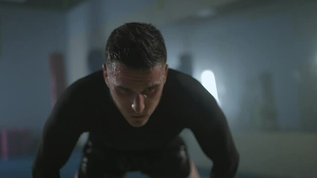 Portrait of a sporty fighter after a hard workout in the boxing gym, self-improvement.