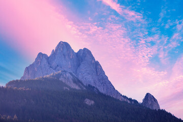 The Dolomites Alps against the sunset sky. View of Mountain ridge during sunrise in the Dolomites,...