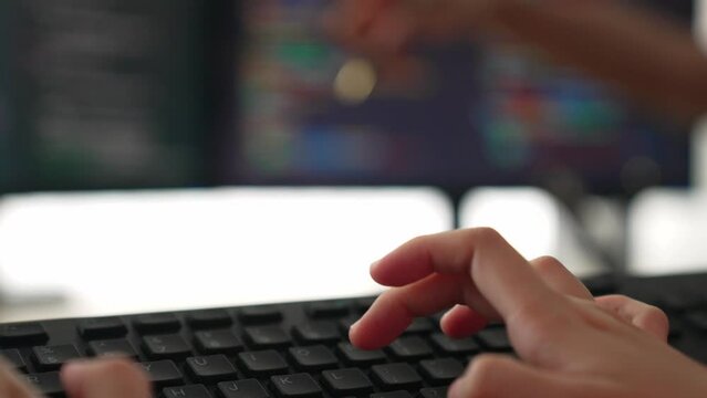Slow motion closeup hand, back end software developer engineer for computer programming working together on debugging writing computing code, solving complex algorithms display on monitor. Burgeoning