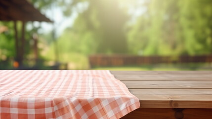 Empty wooden table with tablecloth at nature. 	
