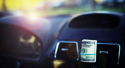 Concept background. dollars with a car key lie in inside cars. financial concept - obrazy, fototapety, plakaty