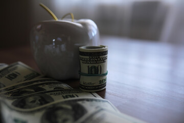 Apple on table with money, dollars banknotes. Us business concept. New york big apple.