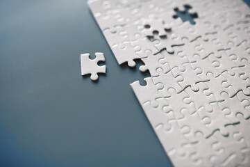 Clean puzzle elements on the red background. Empty puzzle piece on the table. Teamwork concept.