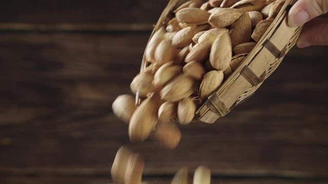 almonds，organic badam falling from bamboo basket.