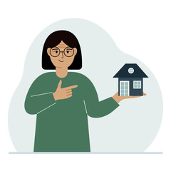 Fototapeta na wymiar A woman holds a small house in his palm. Concepts of inheritance, real estate transfer, mortgage, credit, loan or house purchase.