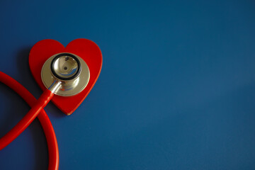 Doctor`s desk in the clinic's office. Stethoscope, puzzle heart, prescriptions on the table.