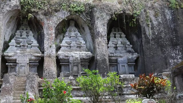 Tourism and travel concept. Old Gunung Kawi Temple with rock-cut tombs of kings. Sacred religious place. Exploration of Asian culture and religion, tourist place on the island Bali