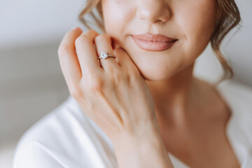 tender hands of a young woman with an expensive ring and a beautiful manicure. Close-up photo of...