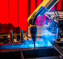Closeup robot arm metal Argon Welding Machine working. Robotic technology in precious automation...