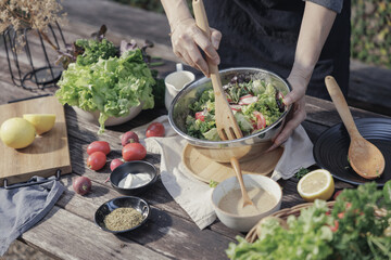 A woman enjoys a healthy salad at a restaurant during a delicious dinner, surrounded by a beautifully set table and gourmet dishes, creating a perfect scene for a banquet or party