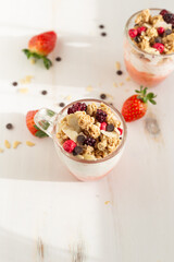 Yogurt with red fruit granola with strawberry cream, almonds and chocolate chips. Healthy snack idea for children.