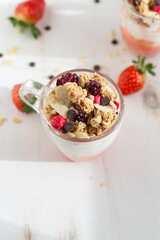 Yogurt with red fruit granola with strawberry cream, almonds and chocolate chips. Healthy snack idea for children.