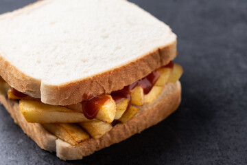 Sliced white bread on black slate background