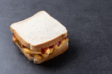 Sliced white bread on black slate background. Copy space