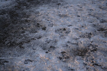 frozen asphalt as a backdrop, snow and ice on the road not cleared, icy conditions 