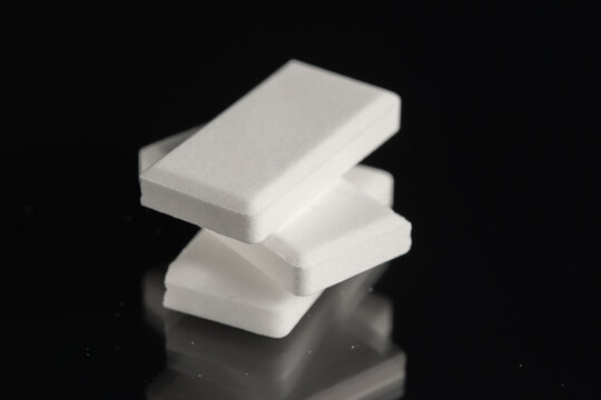 Stack of glucose dextrose candies on black background. Close-up.