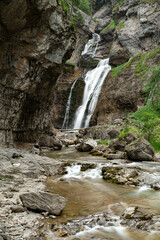Waterfall of the strait (Estrecho waterfall) in the Ordesa Valley National Park in Aragon Pyrenees. Huesca, Spain. Ara river waterfalls.