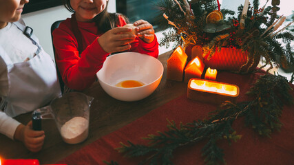 Children preparing Christmas gingerbread in the kitchen