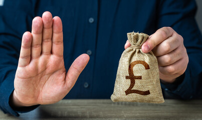 Stop gesture and british pound sterling money bag. Financial difficulties. Asset freeze seizure....